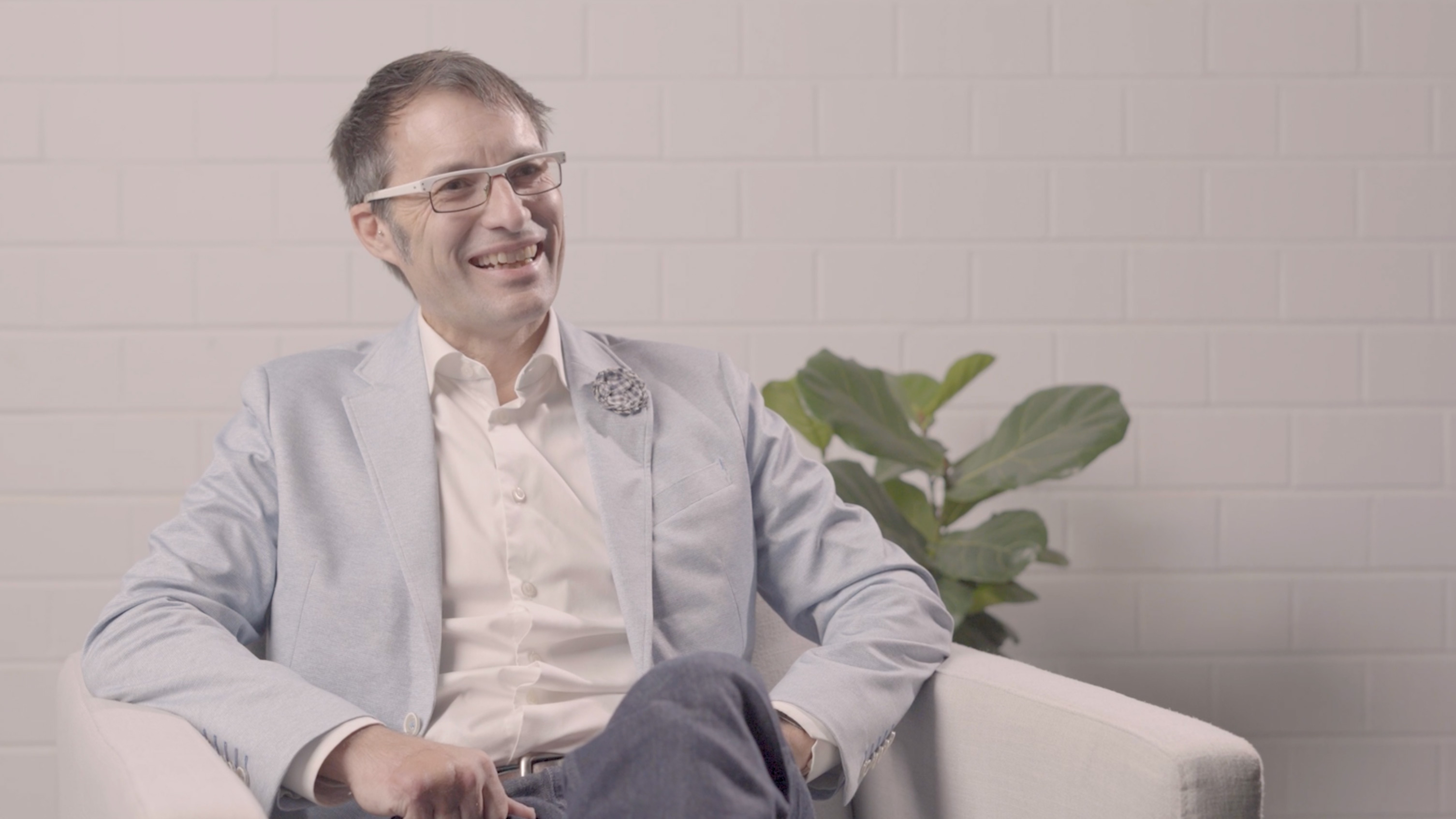 RPS Director - Energy Operations, Australia Asia Pacific, Roger Edgecombe, sits in an armchair smiling with a pot plant behind him. 