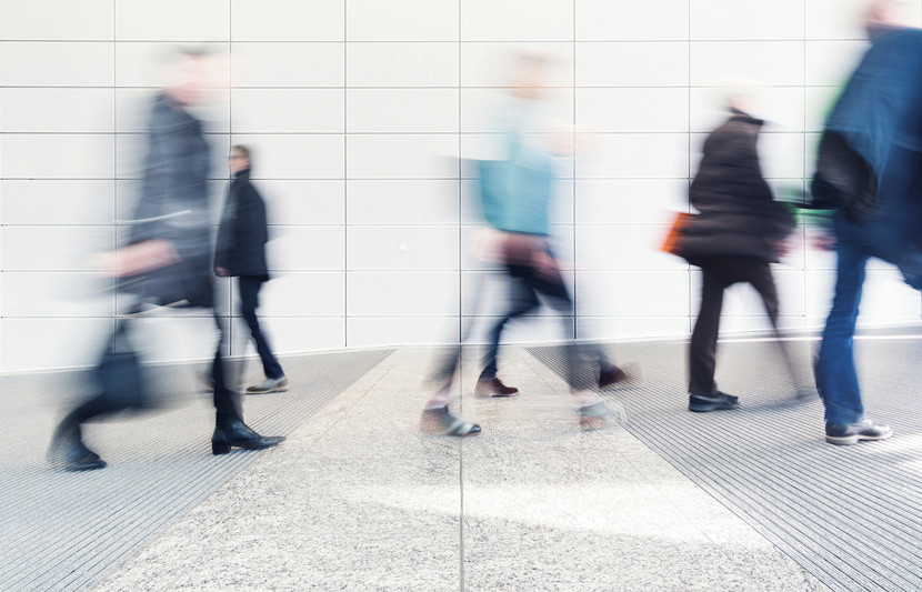 Businesspeople walking quickly in an urban environment