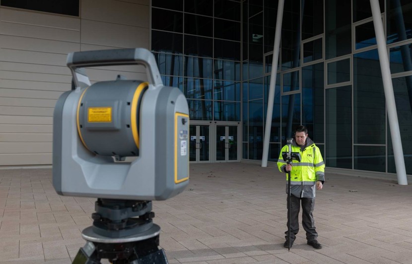 Man standing with surveying equipment