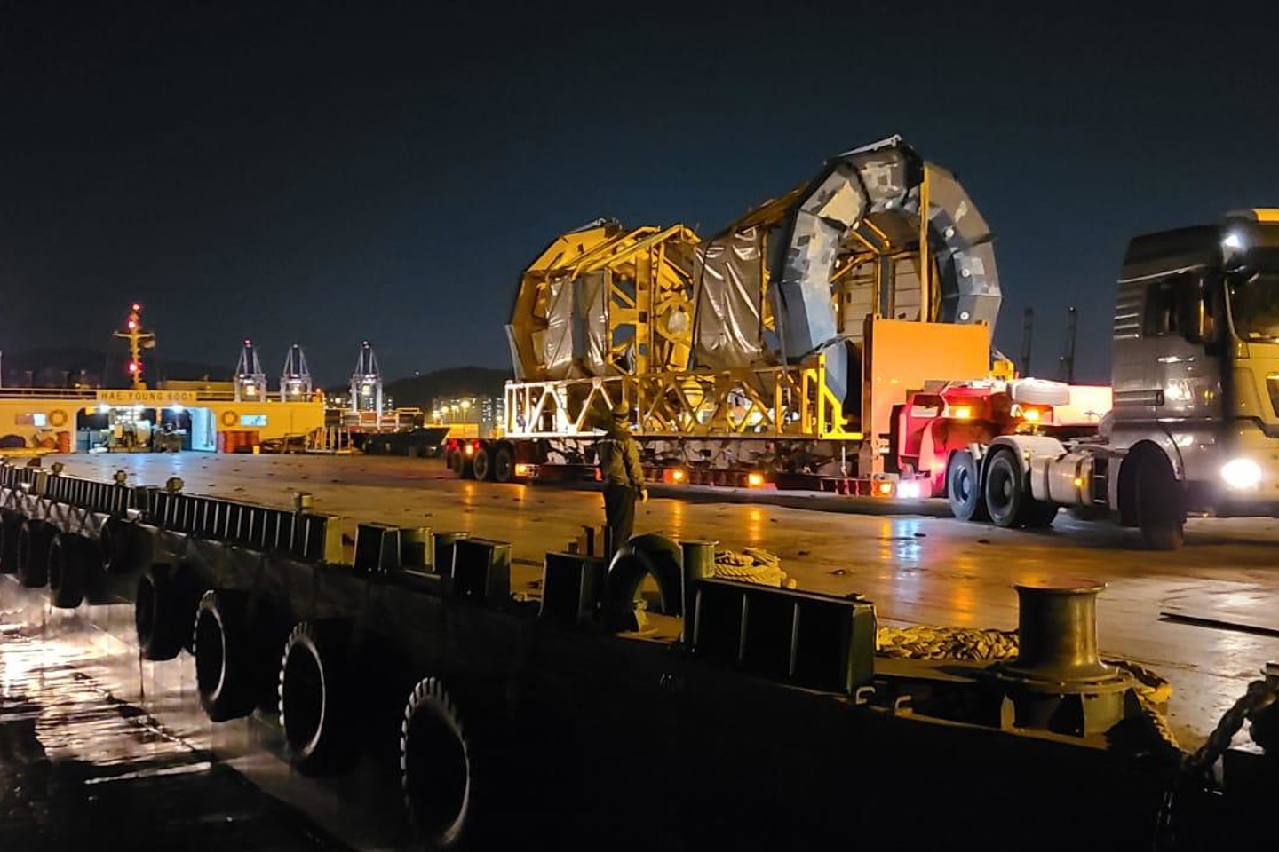 Image of a LiDAR being transported at night on a large truck