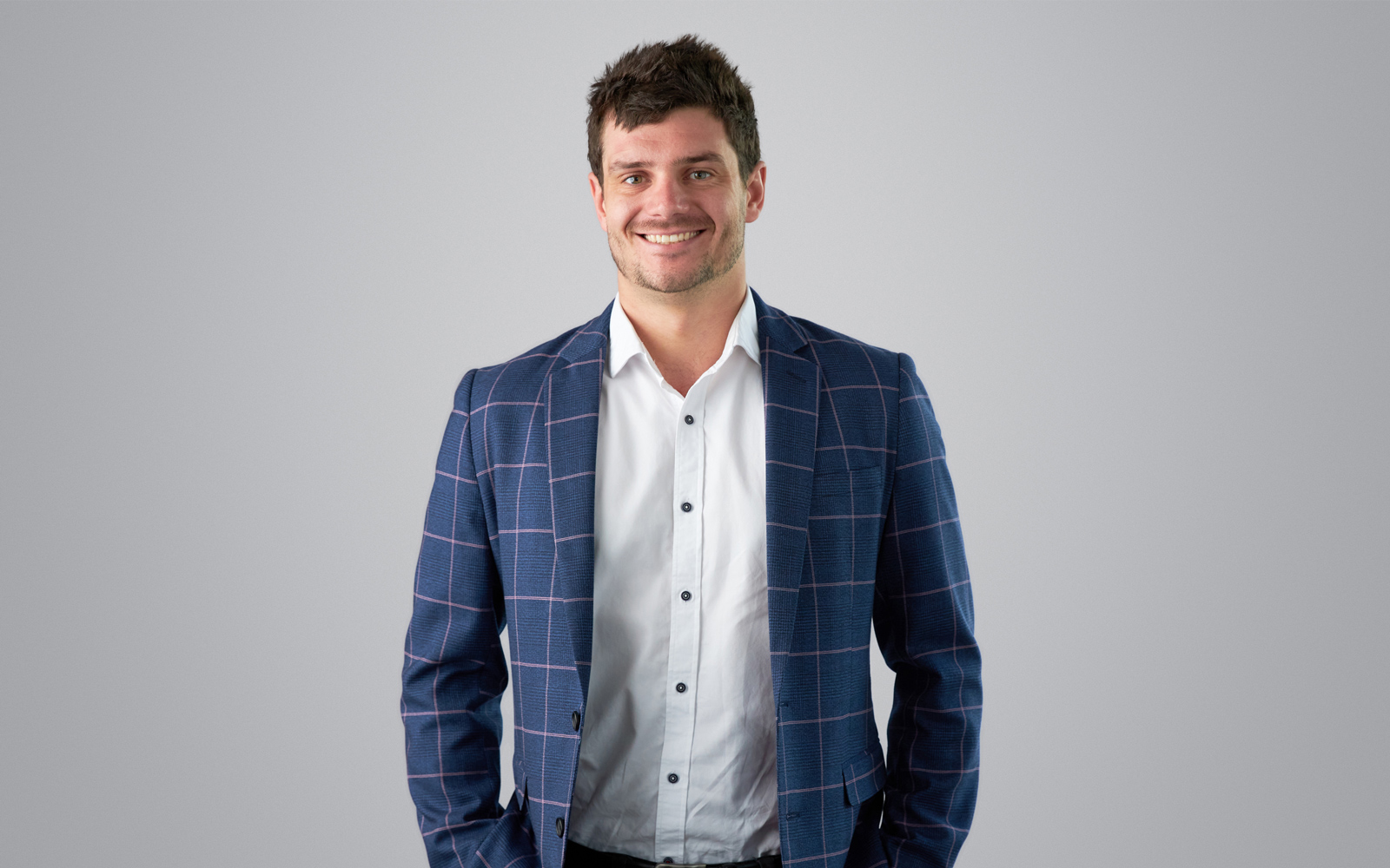 RPS Project Manager Laurence Marin wears blue stripped blazer and white shirt and smiles to camera