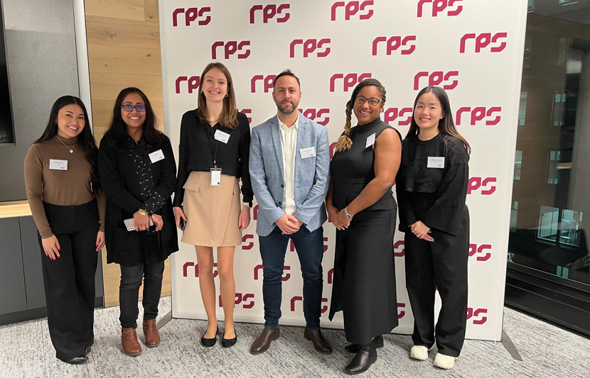 RPS' Cost Advisory Team pose on their second anniversary, with the RPS banner as their backdrop. 