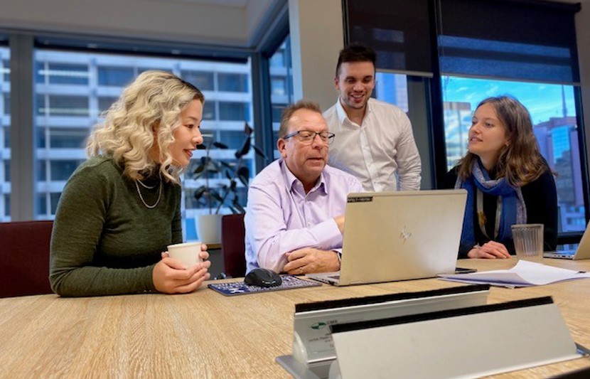 Four commercial advisory team members have an online meeting in boardroom